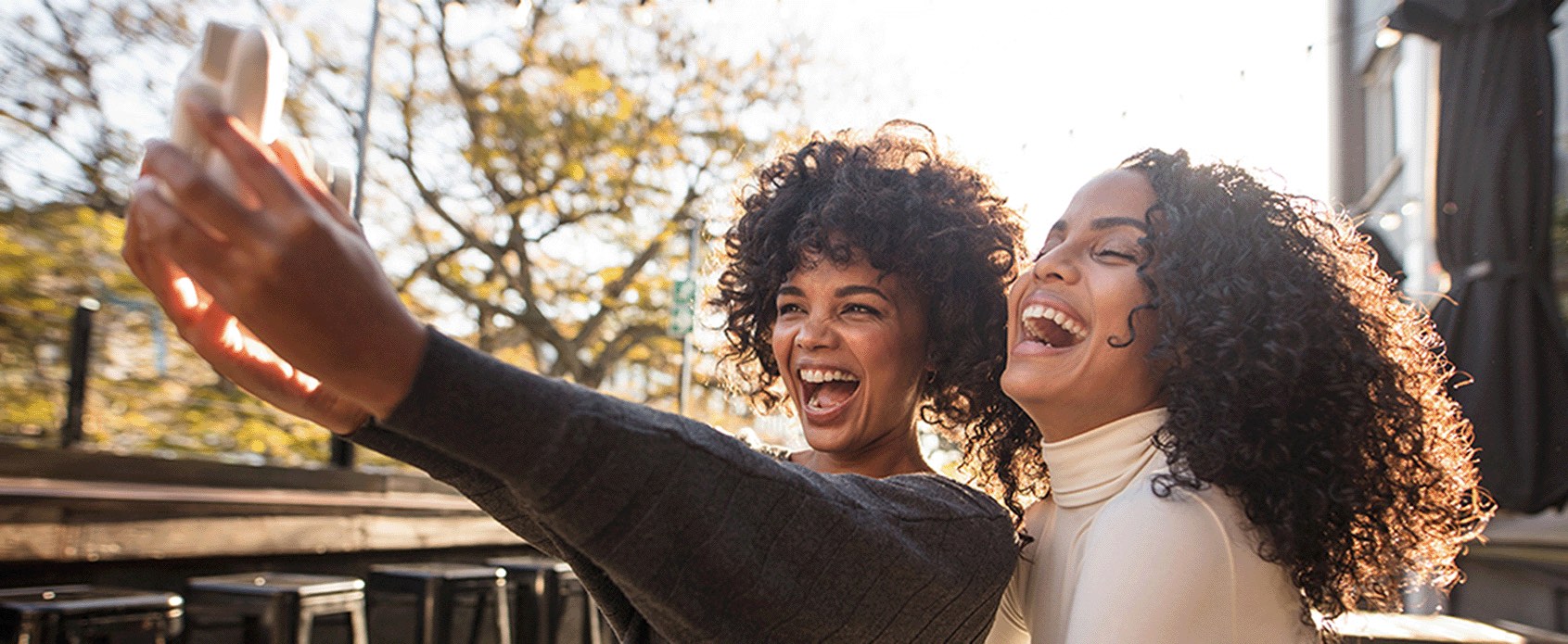 Two women laughing taking a selfie